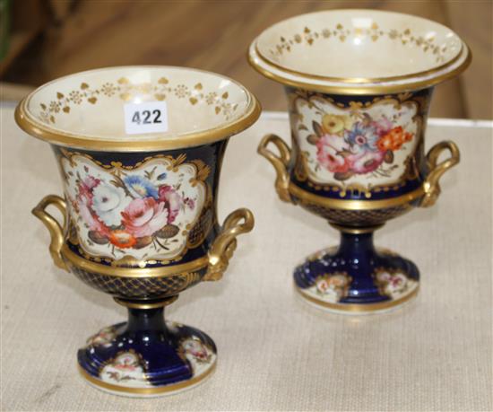 A pair of Victorian Derby style campana vases, painted with panels of flowers within gilt cobalt blue borders, unmarked, height 20cm